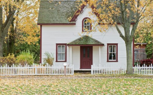 white house under maple trees