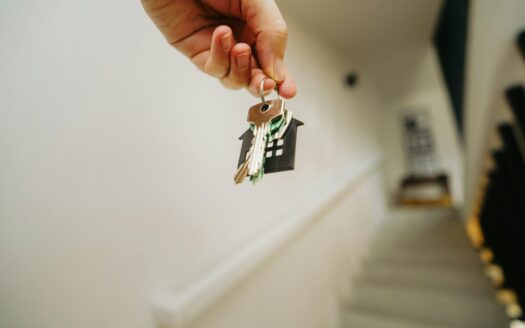 A person holding a house key in their hand