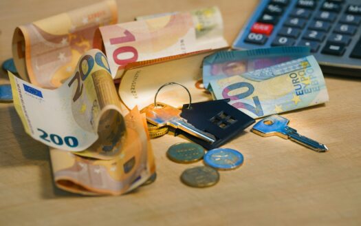 A pile of money sitting next to a calculator